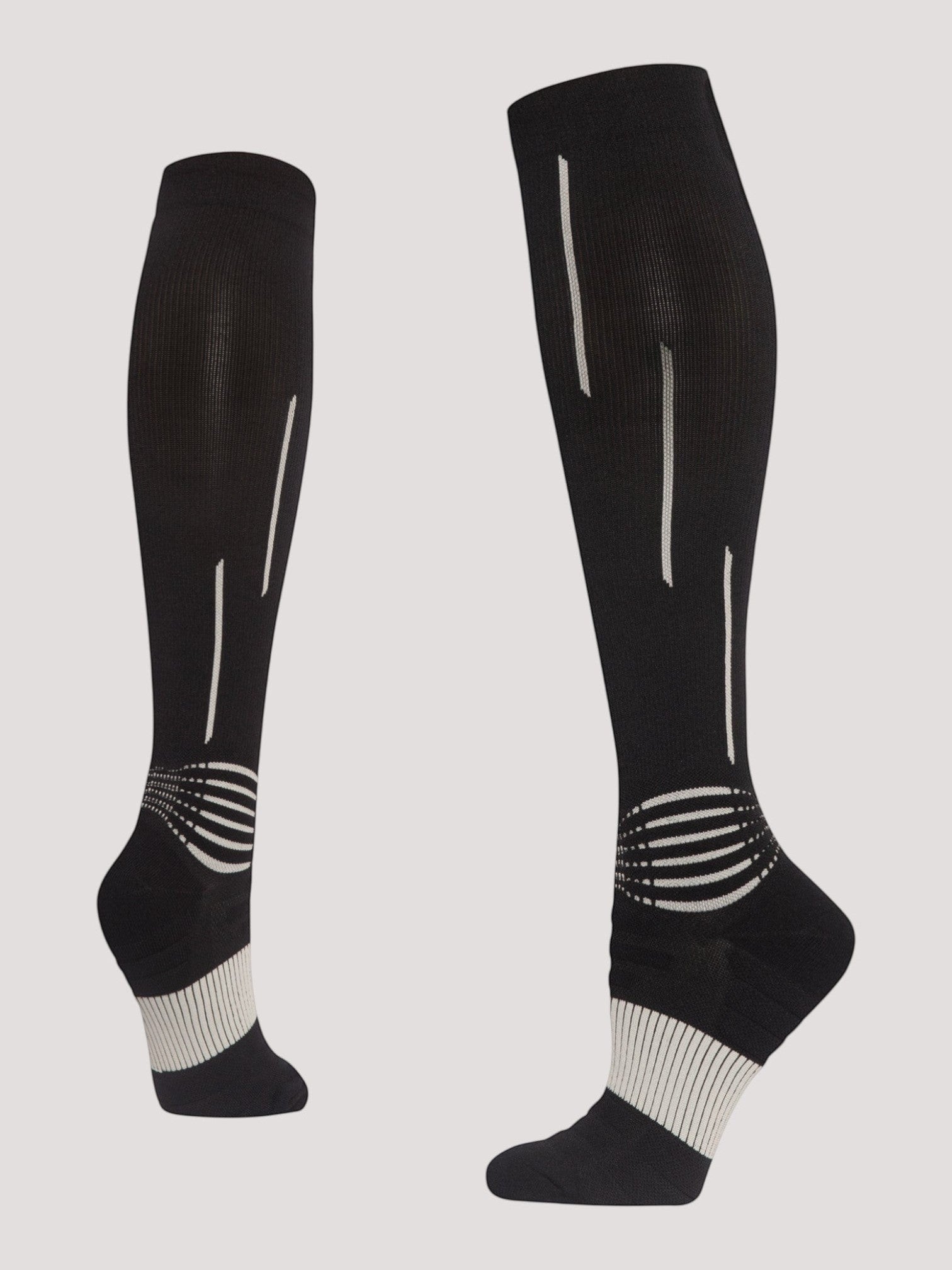 Kotyss black knee-high athletic compression socks with white geometric patterns and reinforced arch support.