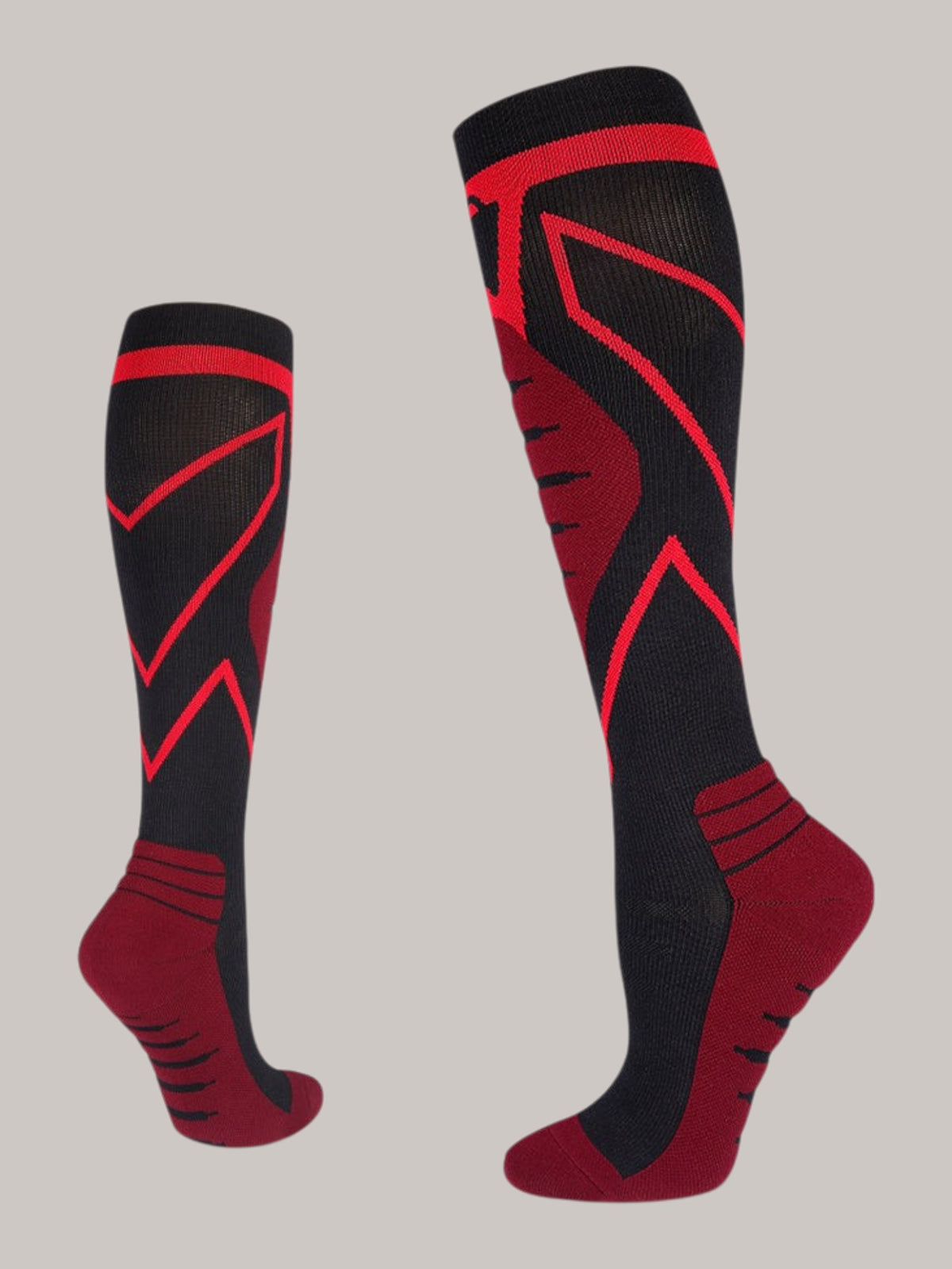 Kotyss knee-high athletic compression socks in black and red with seamless, breathable, and supportive padding.