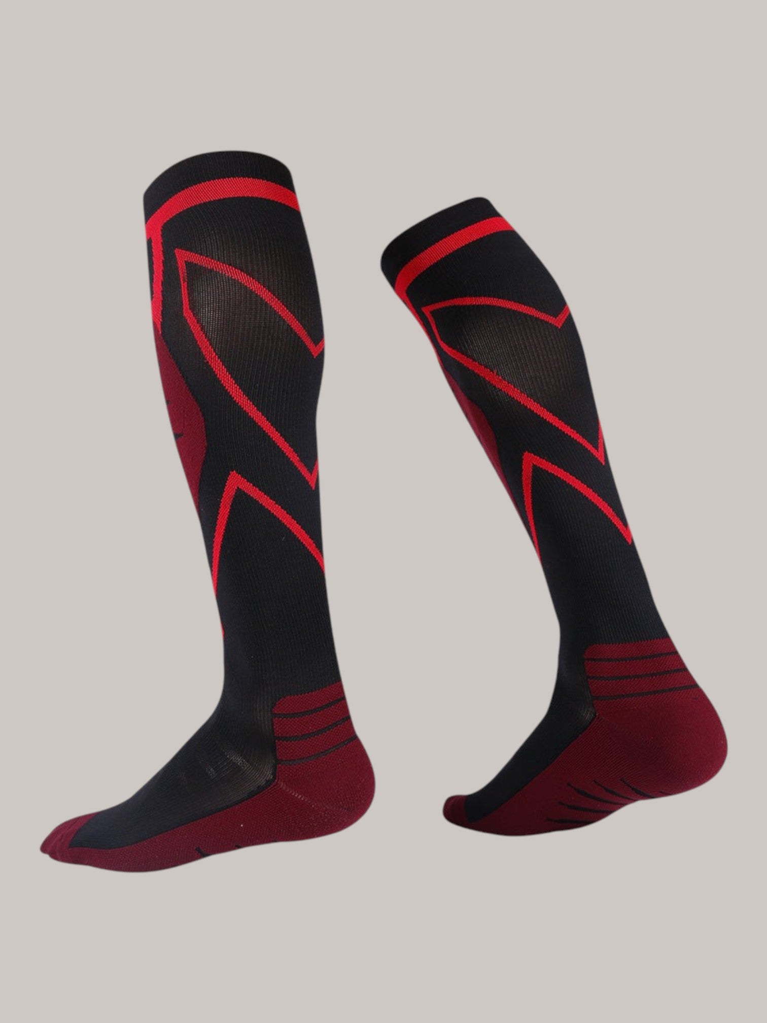 Kotyss knee-high athletic compression socks in black and red with seamless, breathable, and padded design.