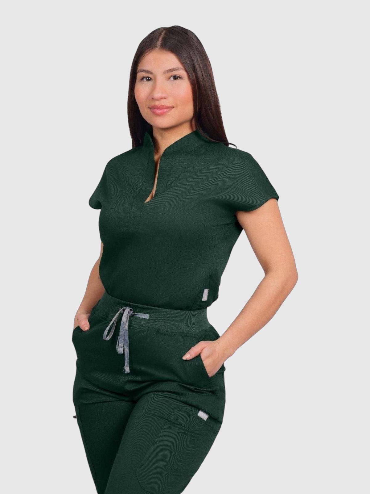 Kotyss women's dark green collared scrub top and jogger set made from soft, breathable, 4-way stretch medical fabric.