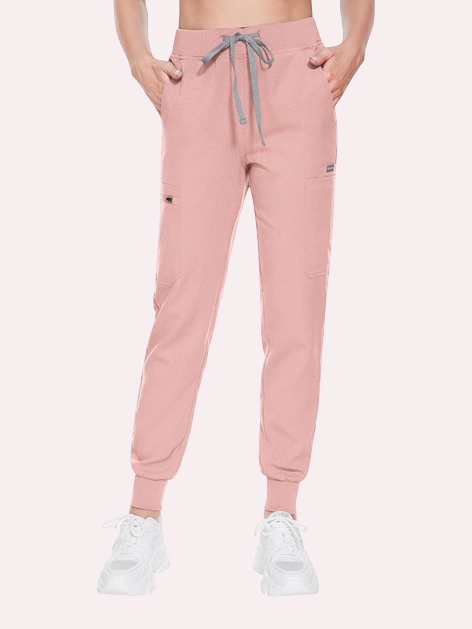 Kotyss women's dusty pink medical scrub jogger pants with a drawstring waist and multiple utility pockets