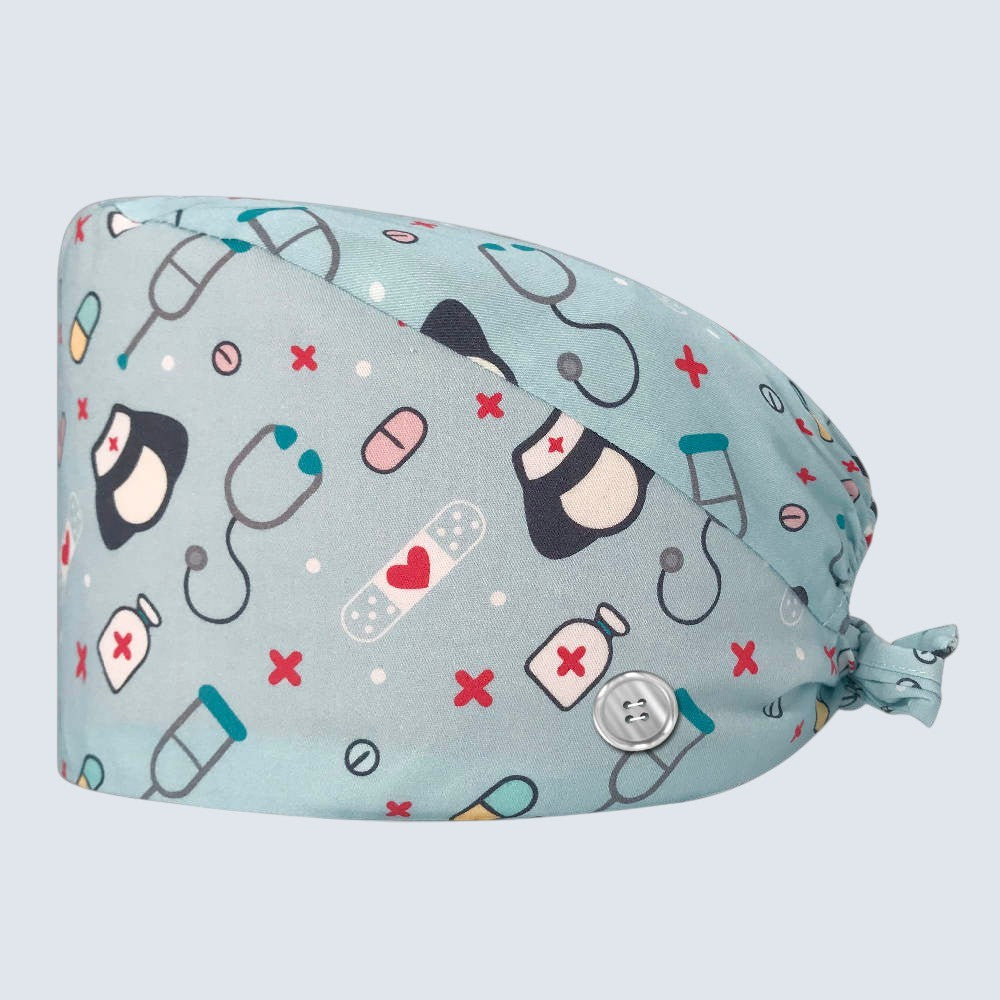 Kotyss unisex scrub cap in light blue with medical pattern, featuring adjustable back ties and side buttons.