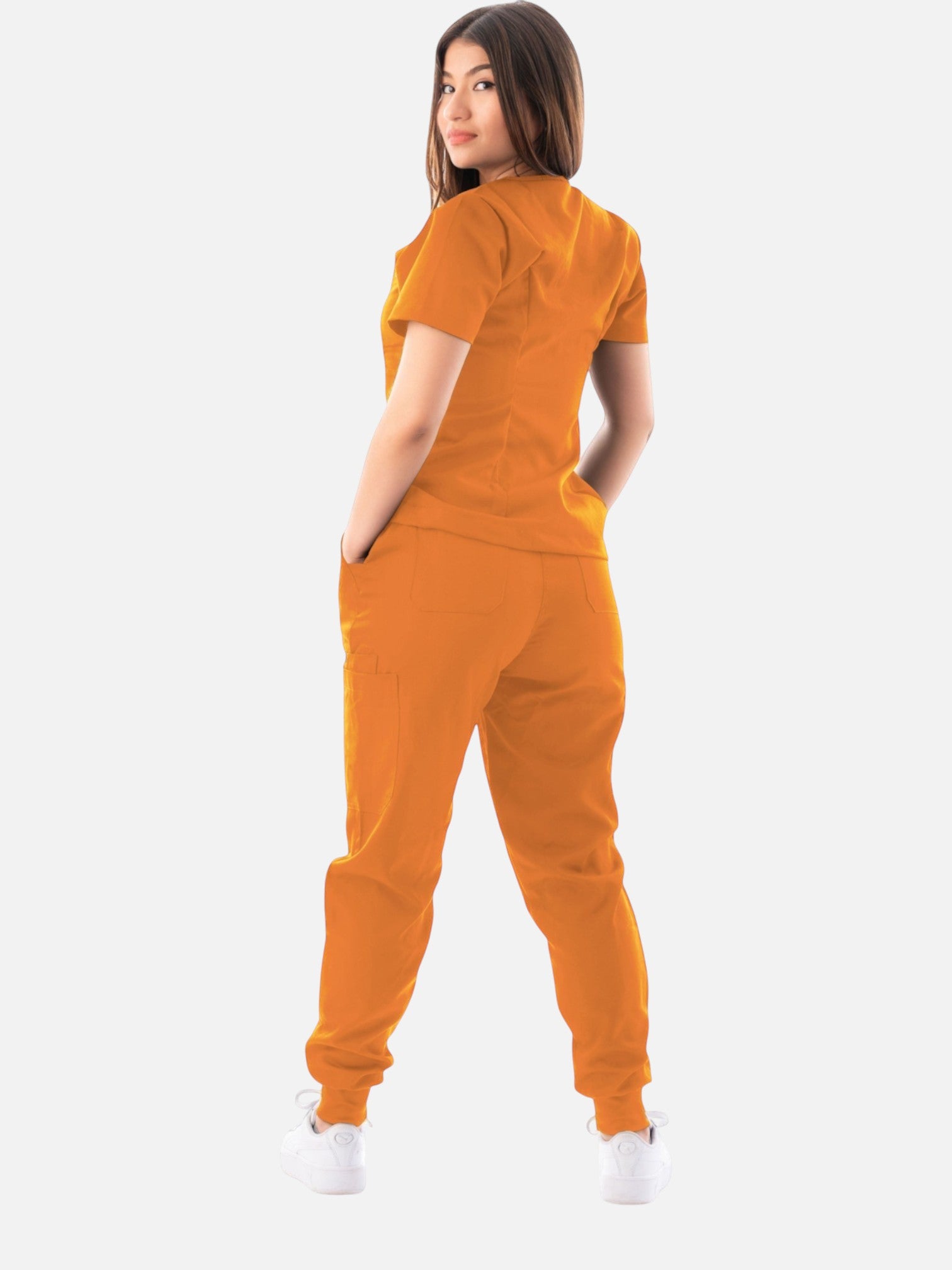 Kotyss women's orange V-neck scrub top and jogger pants set with multiple pockets, worn by a model from behind.