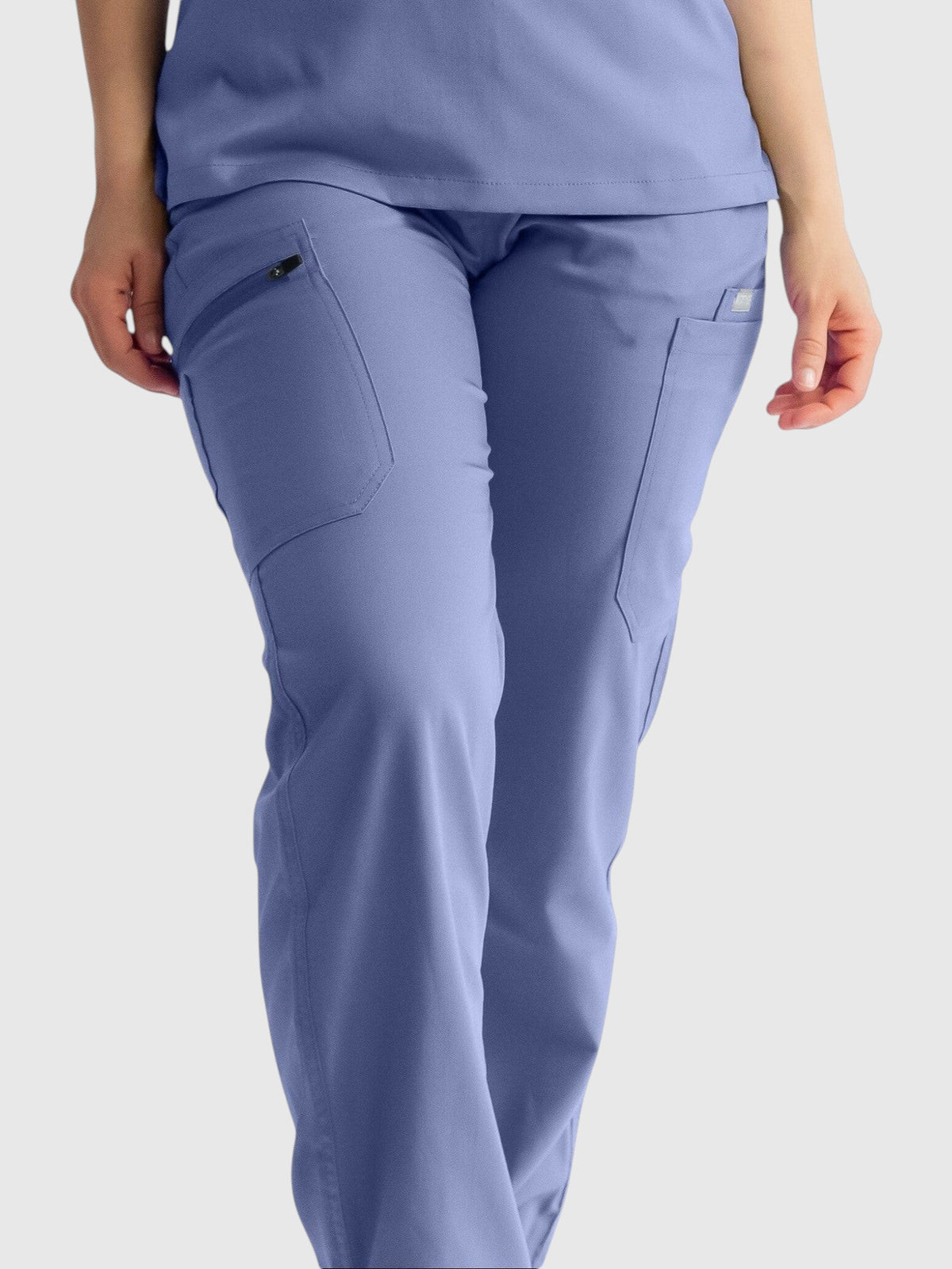 Kotyss straight cut medical scrub pants in periwinkle blue featuring multiple utility pockets and 4-way stretch fabric.