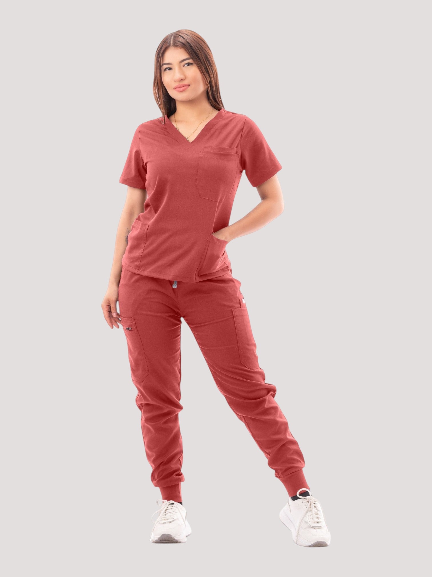 Kotyss women's terracotta V-neck scrub top and jogger pants set with multiple pockets on a model
