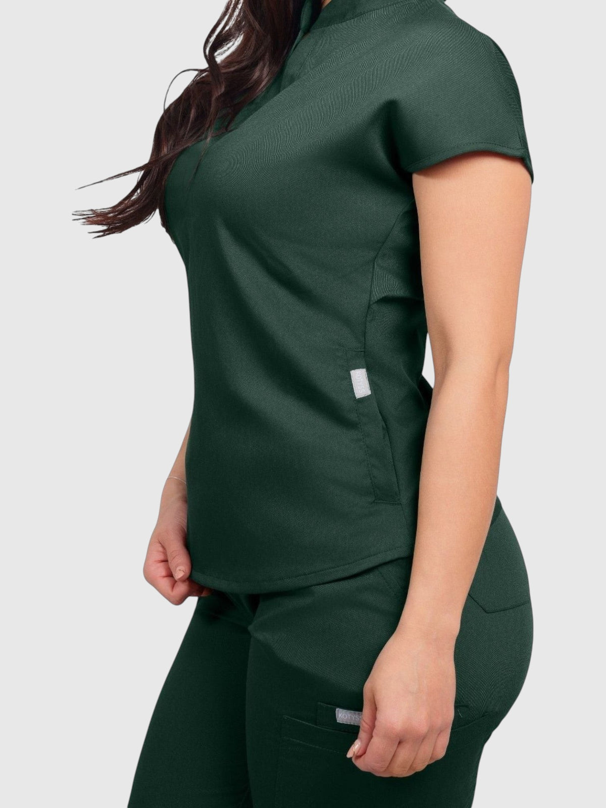 Kotyss women's dark green collared scrub top and matching jogger pants made from breathable 4-way stretch fabric.