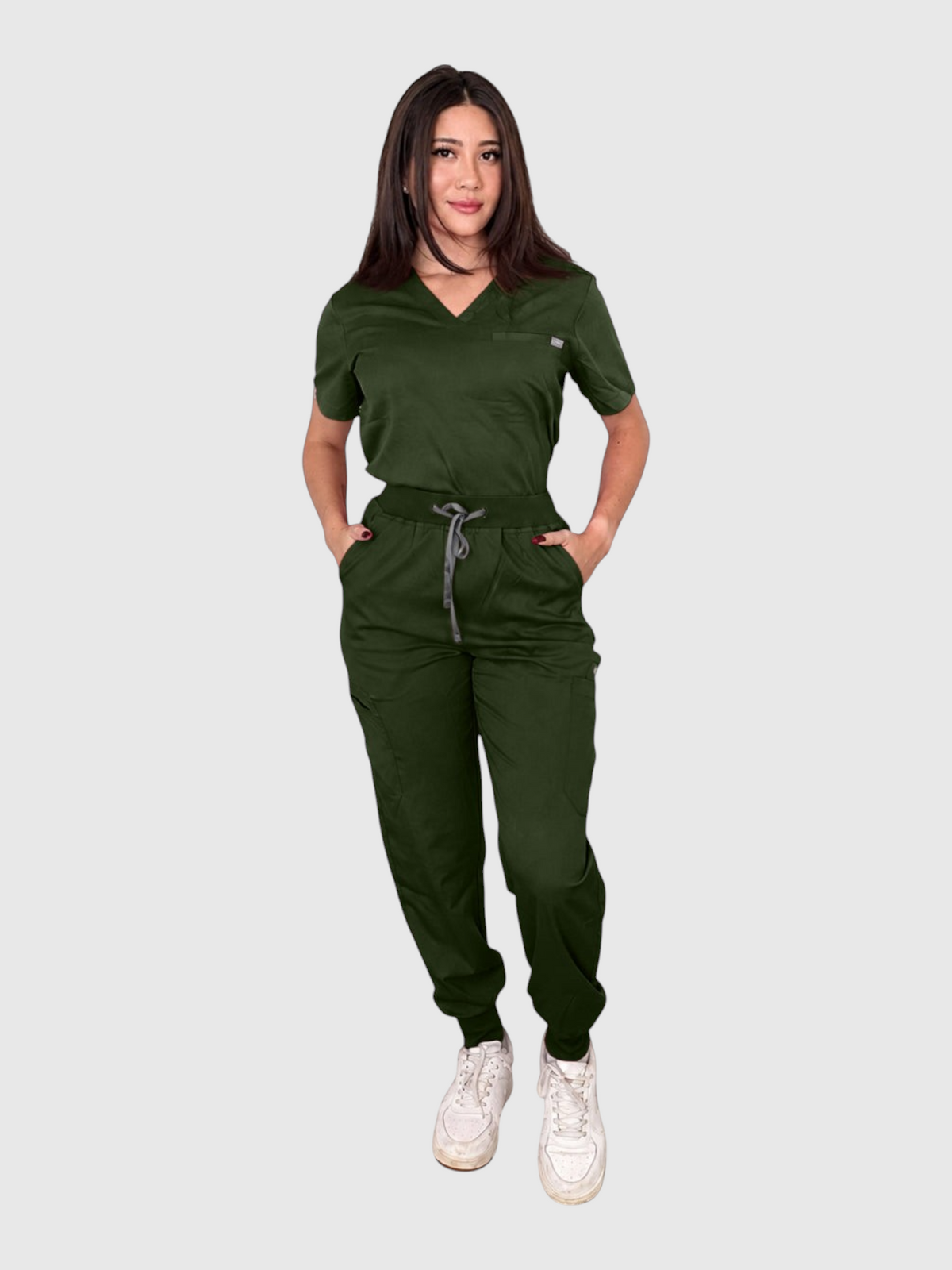 Kotyss women's dark green V-neck scrub top and jogger pants set with multiple pockets on a model.