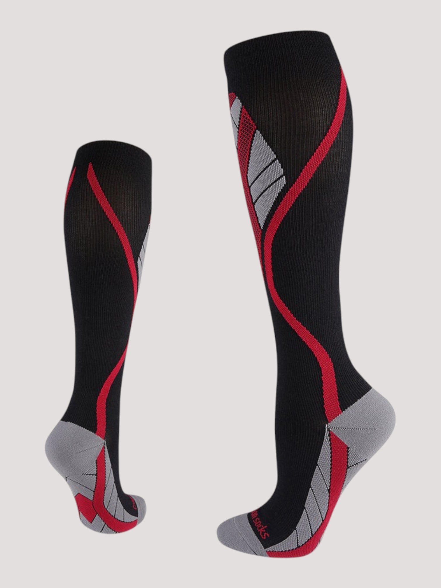 Kotyss unisex knee-high compression socks in black with red and grey athletic patterns and seamless design