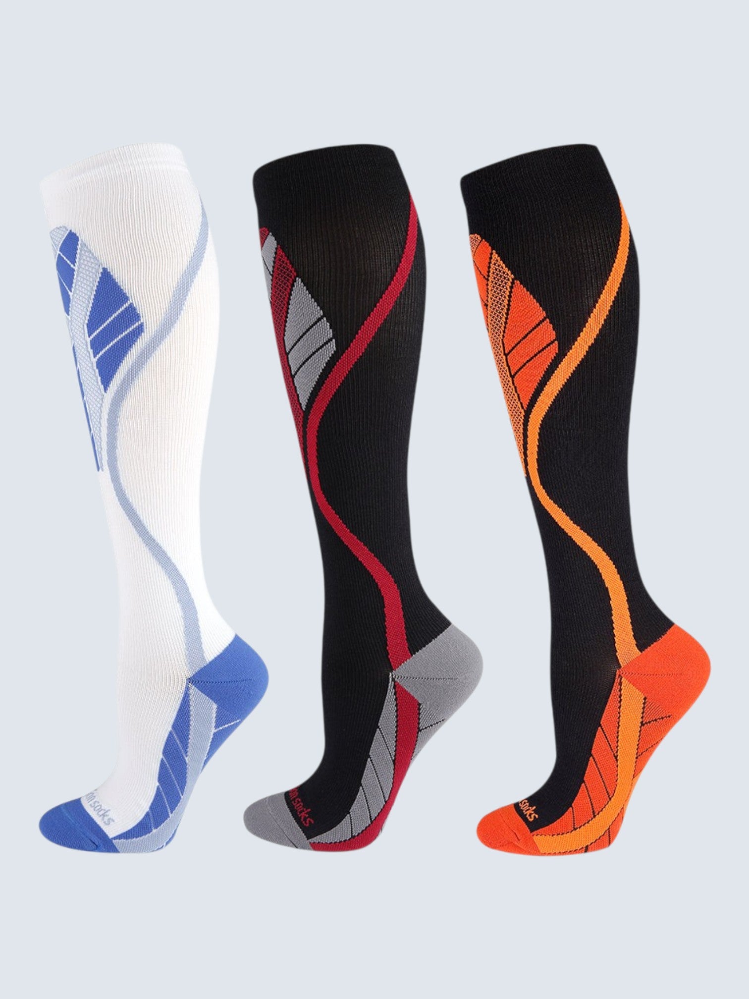 Kotyss knee high athletic compression socks in white, black and red, and black and orange with seamless design.