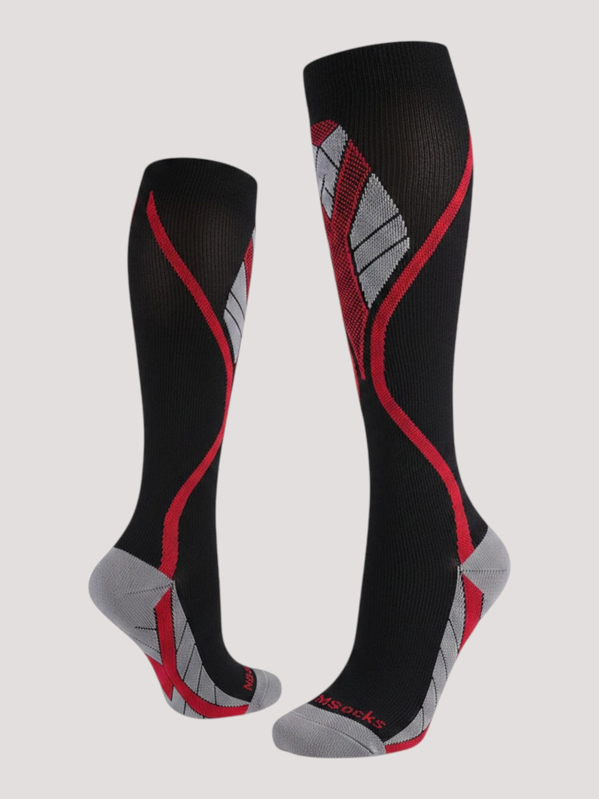 Kotyss knee high compression socks in black with red and grey athletic patterns and reinforced toe and heel padding.