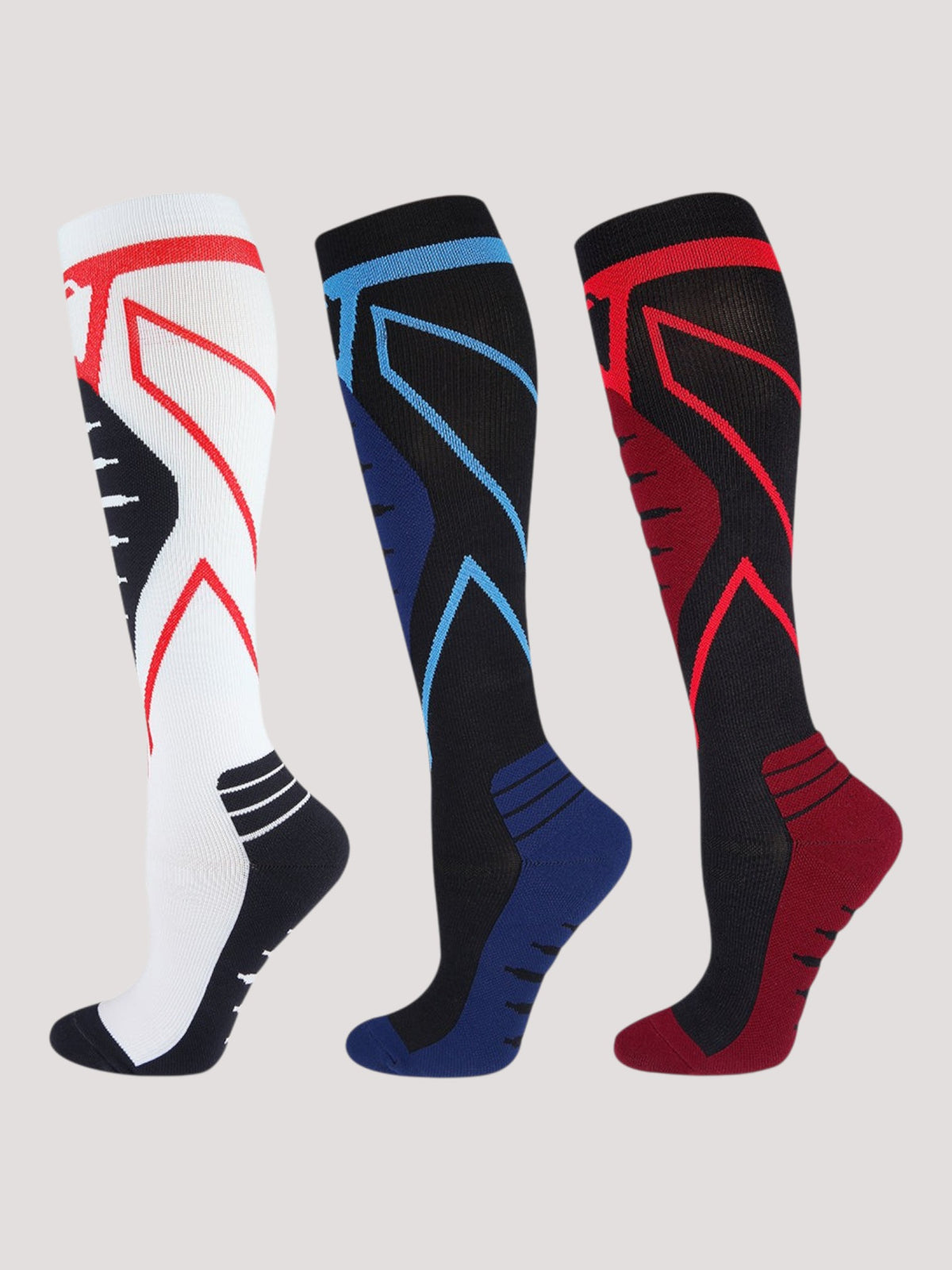 Kotyss unisex knee-high compression socks in white, black, and red with seamless breathable athletic design.