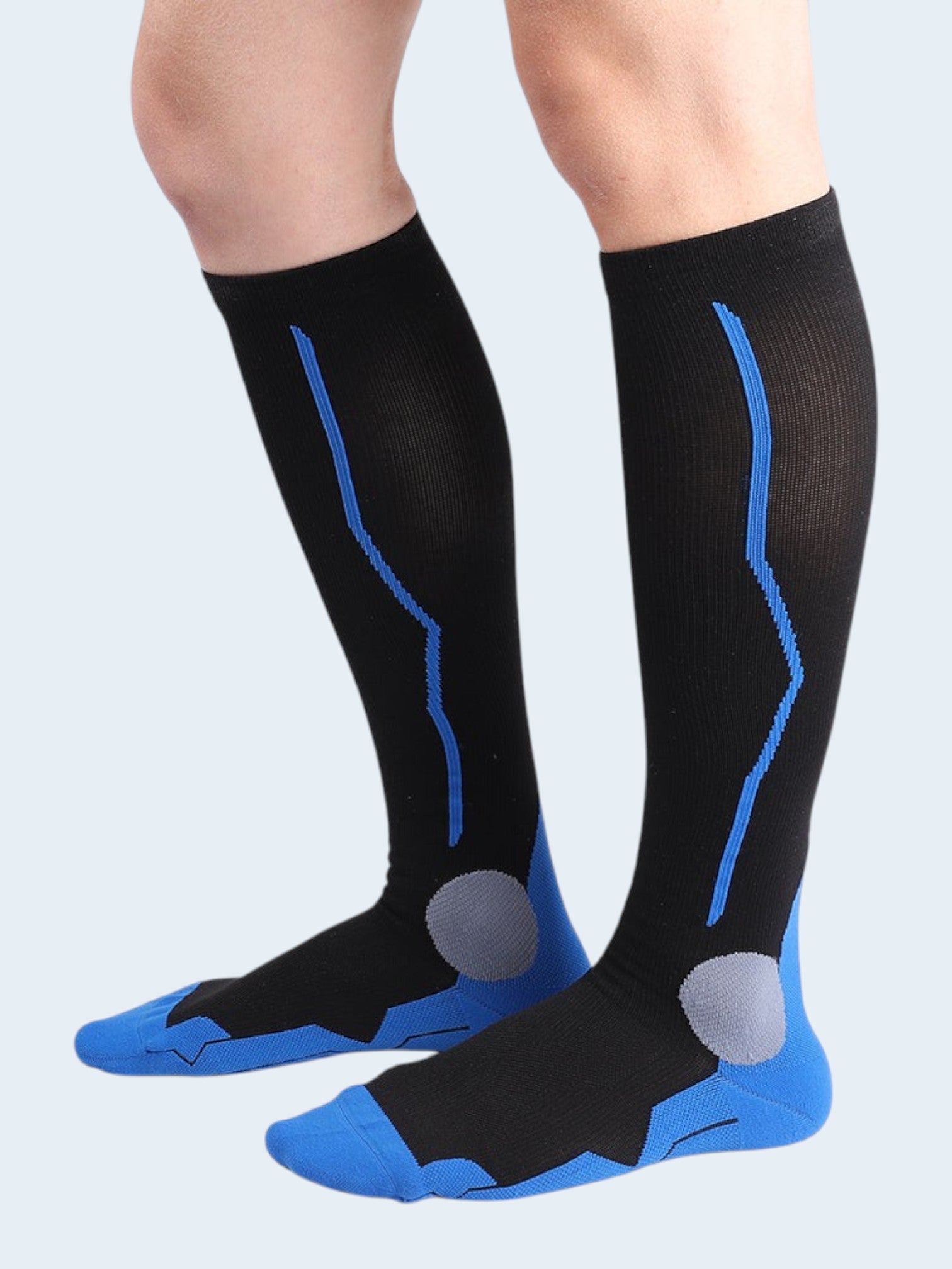 Kotyss black and blue knee high compression socks with seamless design and targeted padding on feet and ankles.
