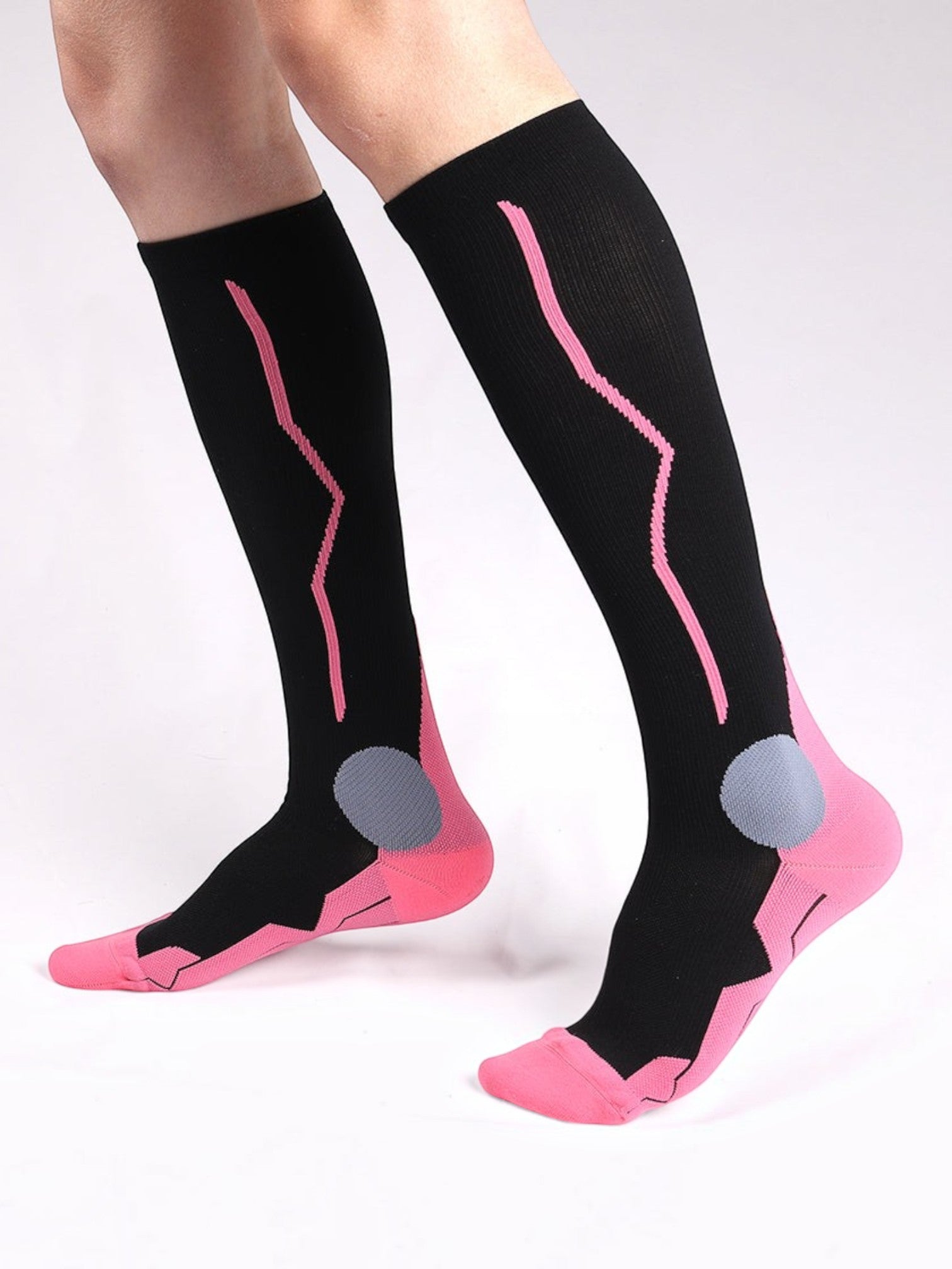 Kotyss knee high compression socks in black and pink with seamless breathable fabric and padded heel support