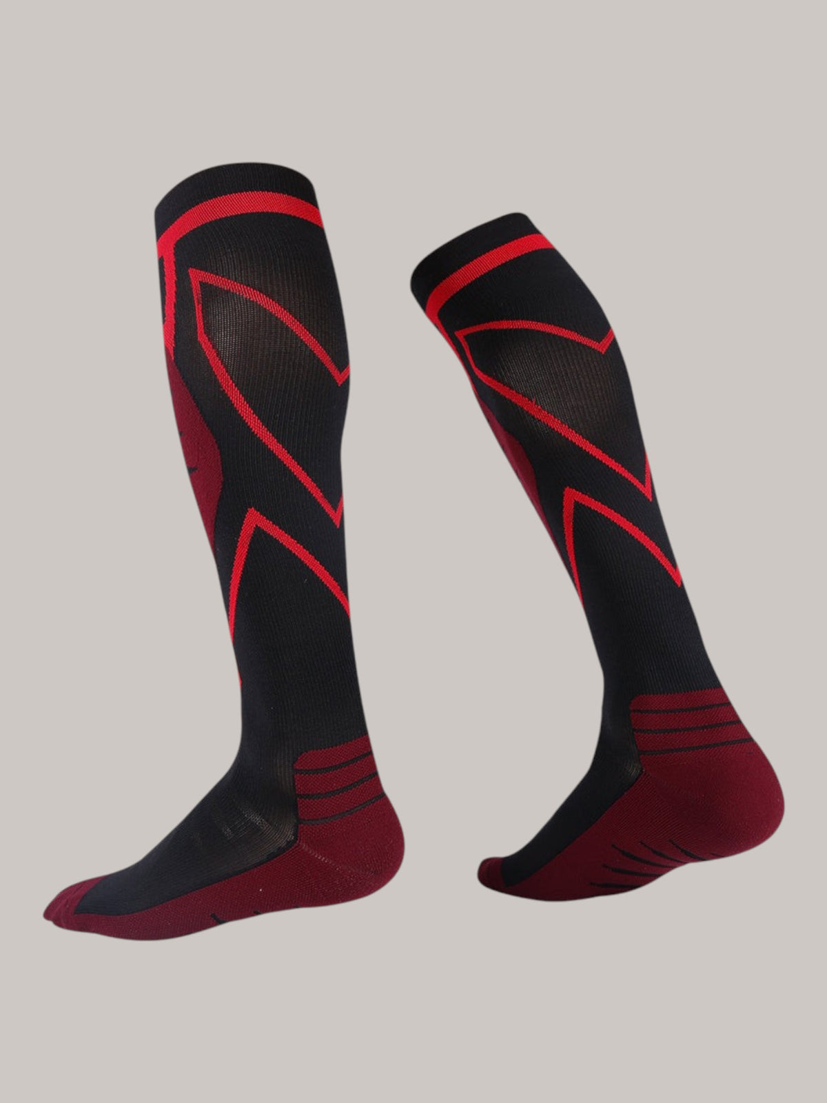 Kotyss knee-high athletic compression socks in black and red with seamless, breathable, and padded design.