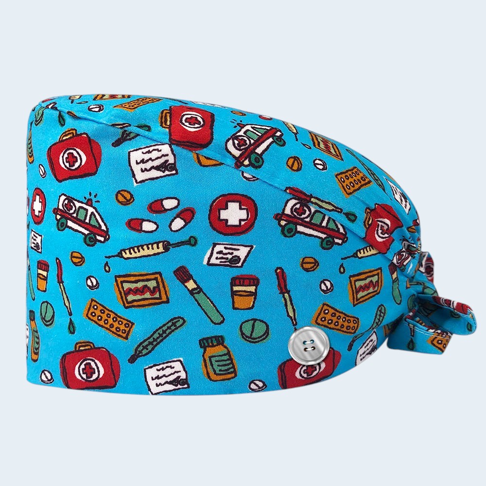 Kotyss unisex scrub cap in blue with a medical-themed print featuring ambulances, pills, and syringes with buttons.