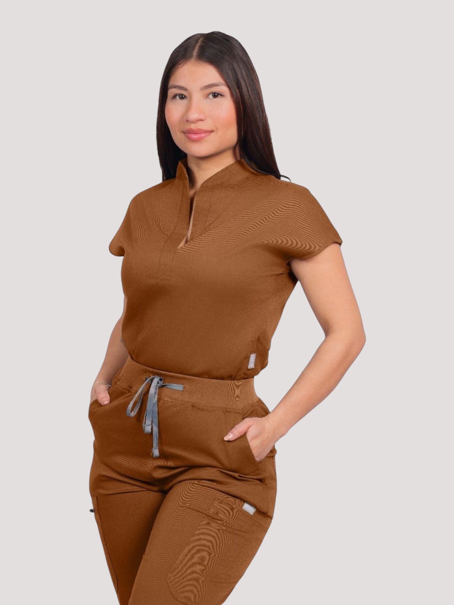 Kotyss women's brown collared scrub top and jogger set with 4-way stretch fabric and multiple utility pockets.