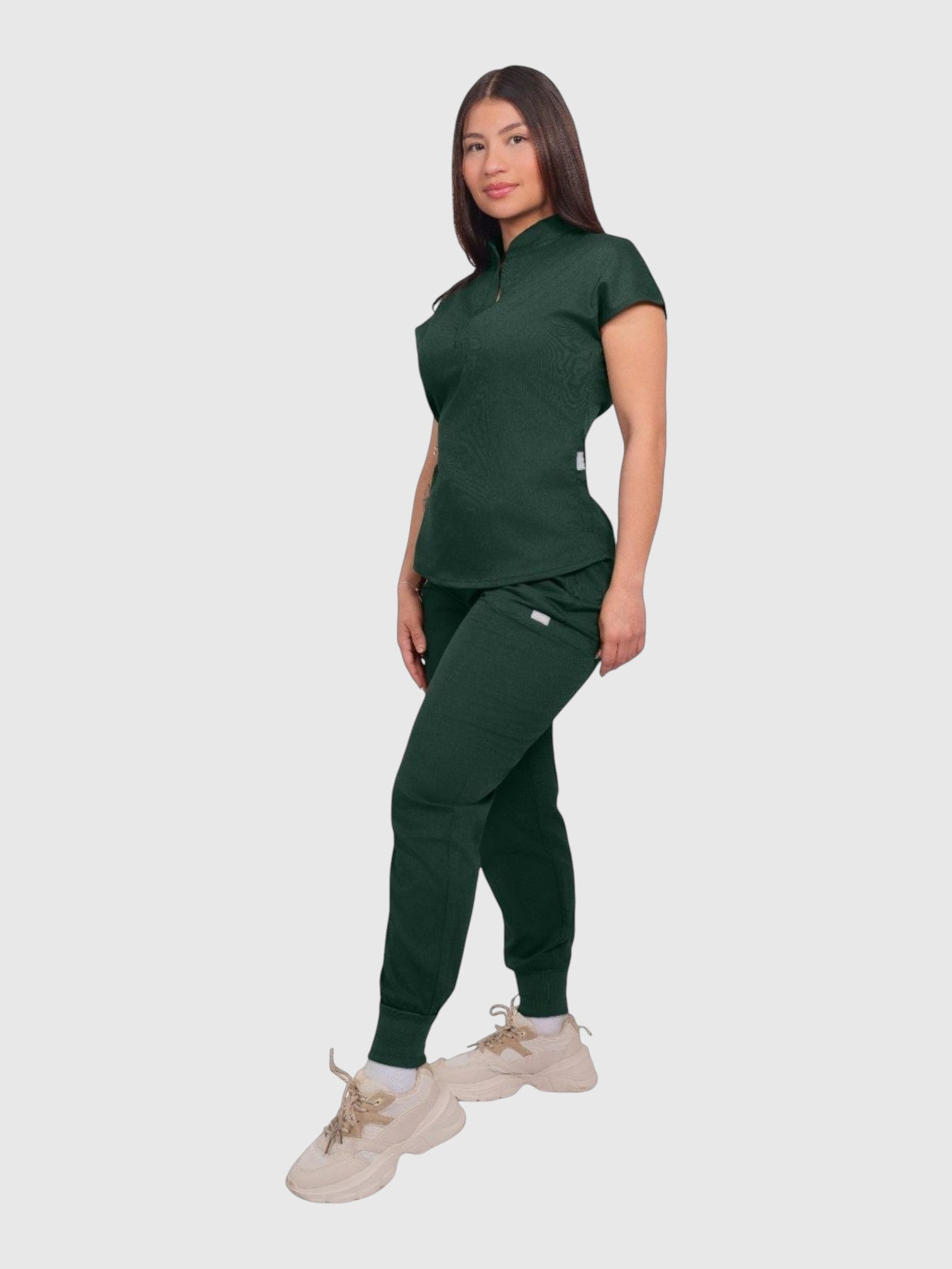 Kotyss women's dark green collared scrub top and jogger set in breathable, anti-microbial 4-way stretch fabric.