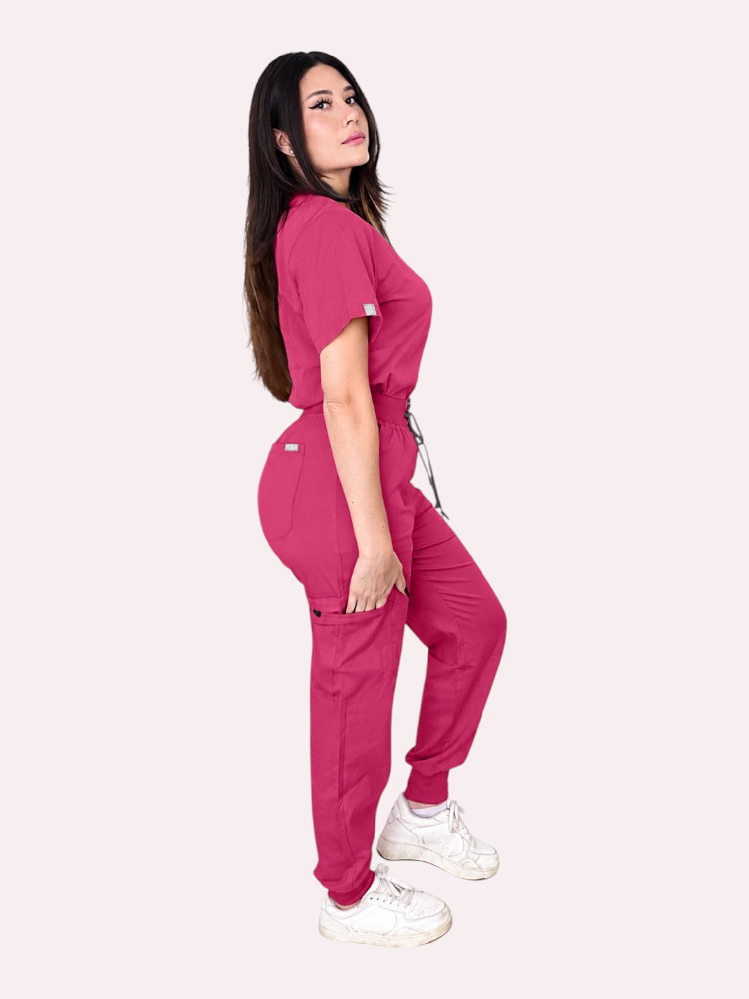Kotyss women's fuchsia pink V-neck scrub top and jogger pants set with multiple pockets on a model