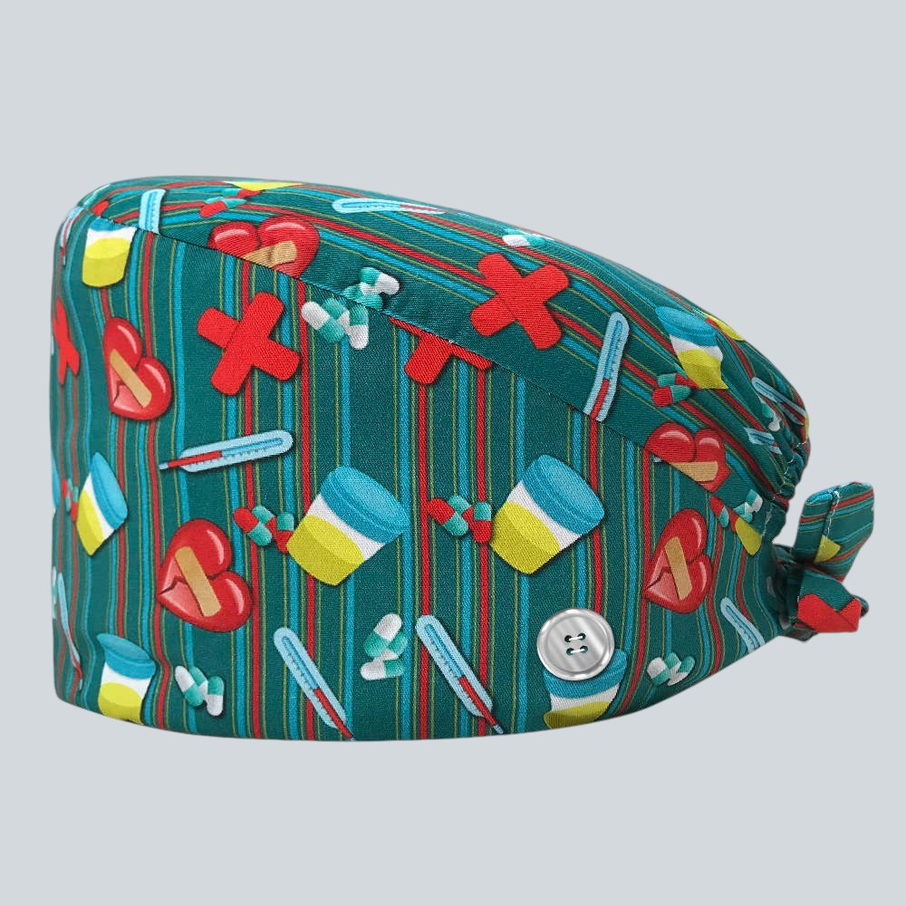 Kotyss unisex scrub cap in green with medical print, featuring adjustable back ties and side buttons for masks.