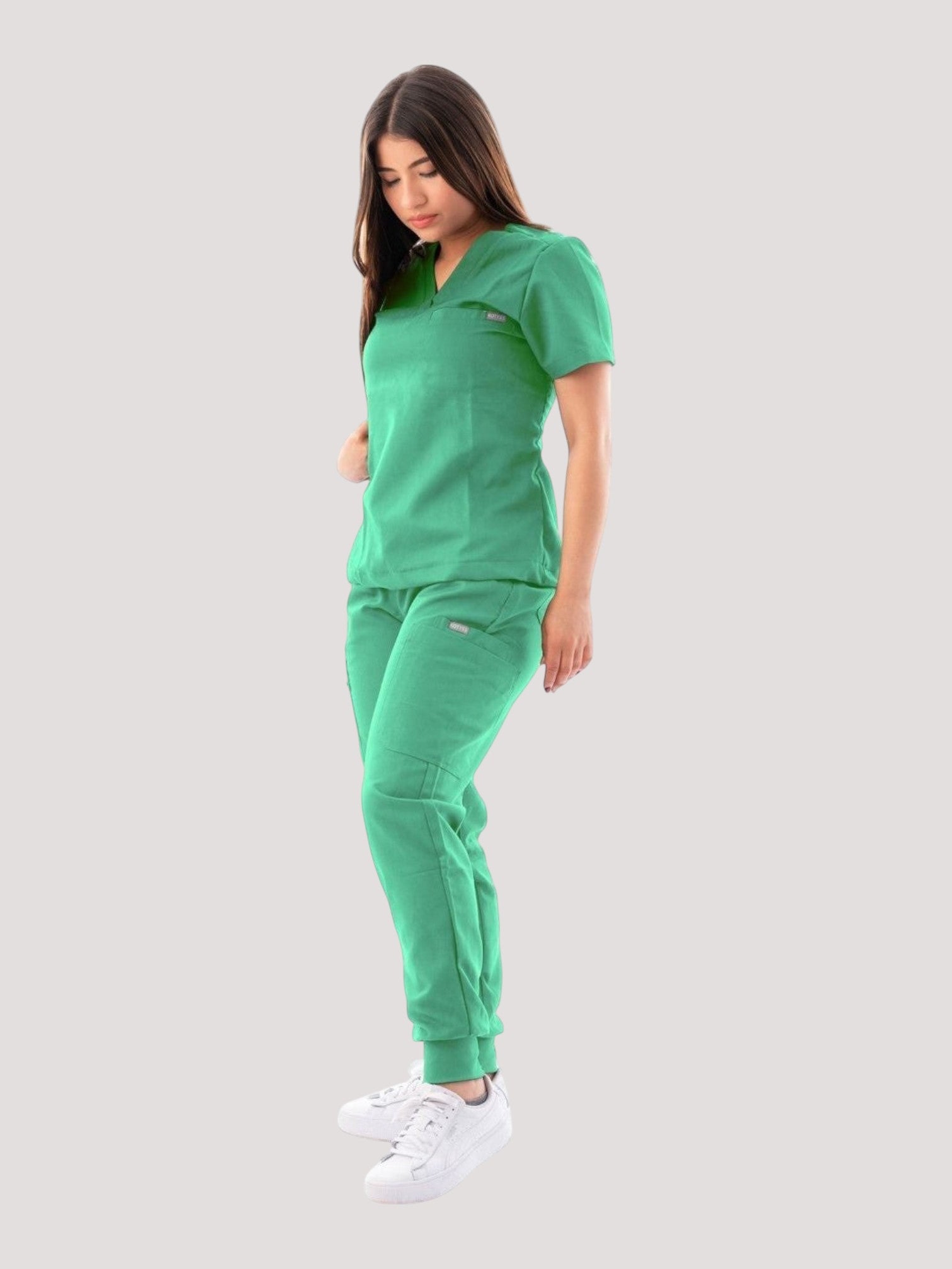 Kotyss women's green V-neck scrub top and jogger pants set with 4-way stretch fabric on a model