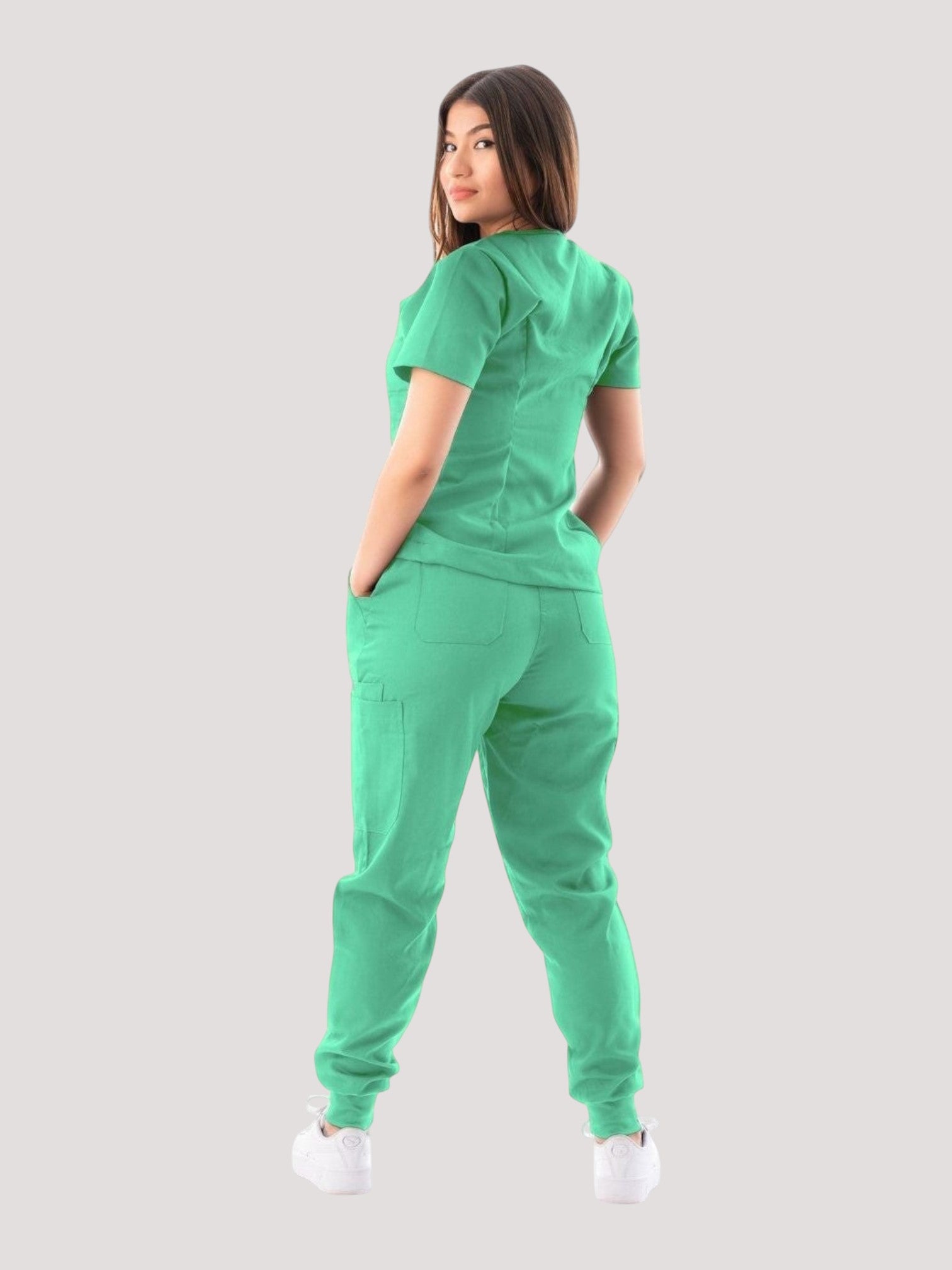 Kotyss women's green V-neck scrub top and jogger pants set, back view showing multiple pockets and athletic fit.