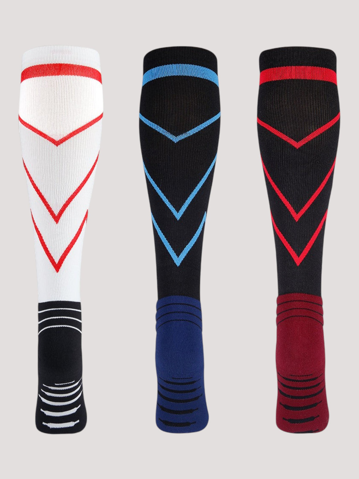 Kotyss knee-high compression socks in white, black, and red with chevron patterns and reinforced heel and toe padding.