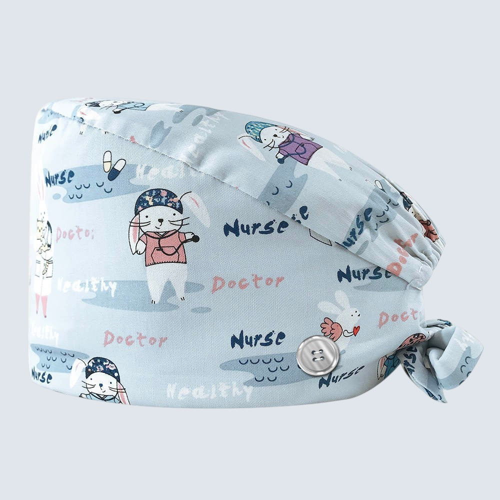 Kotyss unisex scrub cap in light blue with cute bunny doctor and nurse print, featuring adjustable tie-back and buttons