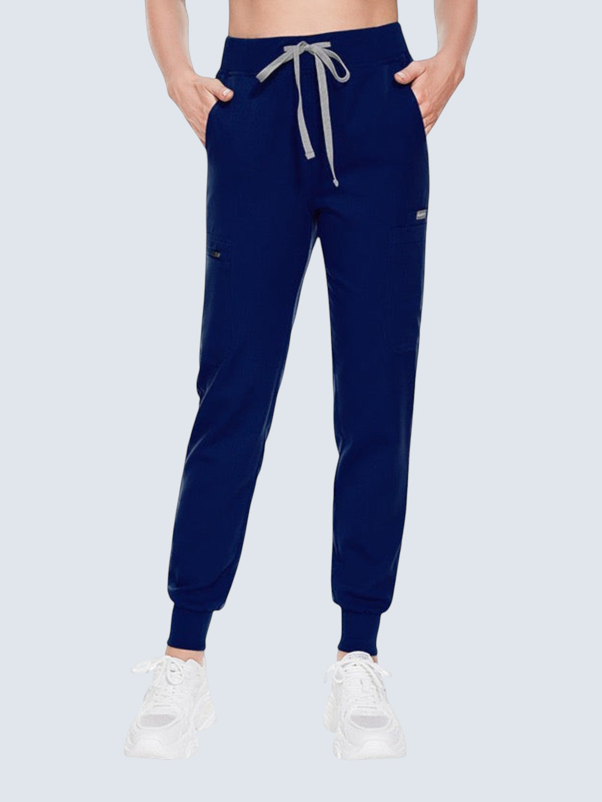 Kotyss navy blue medical scrub jogger pants with a drawstring waist and multiple utility pockets on a model
