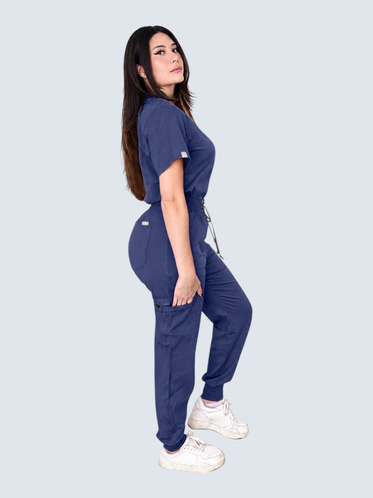Kotyss women's navy blue V-neck scrub top and multi-pocket jogger pants set on a model