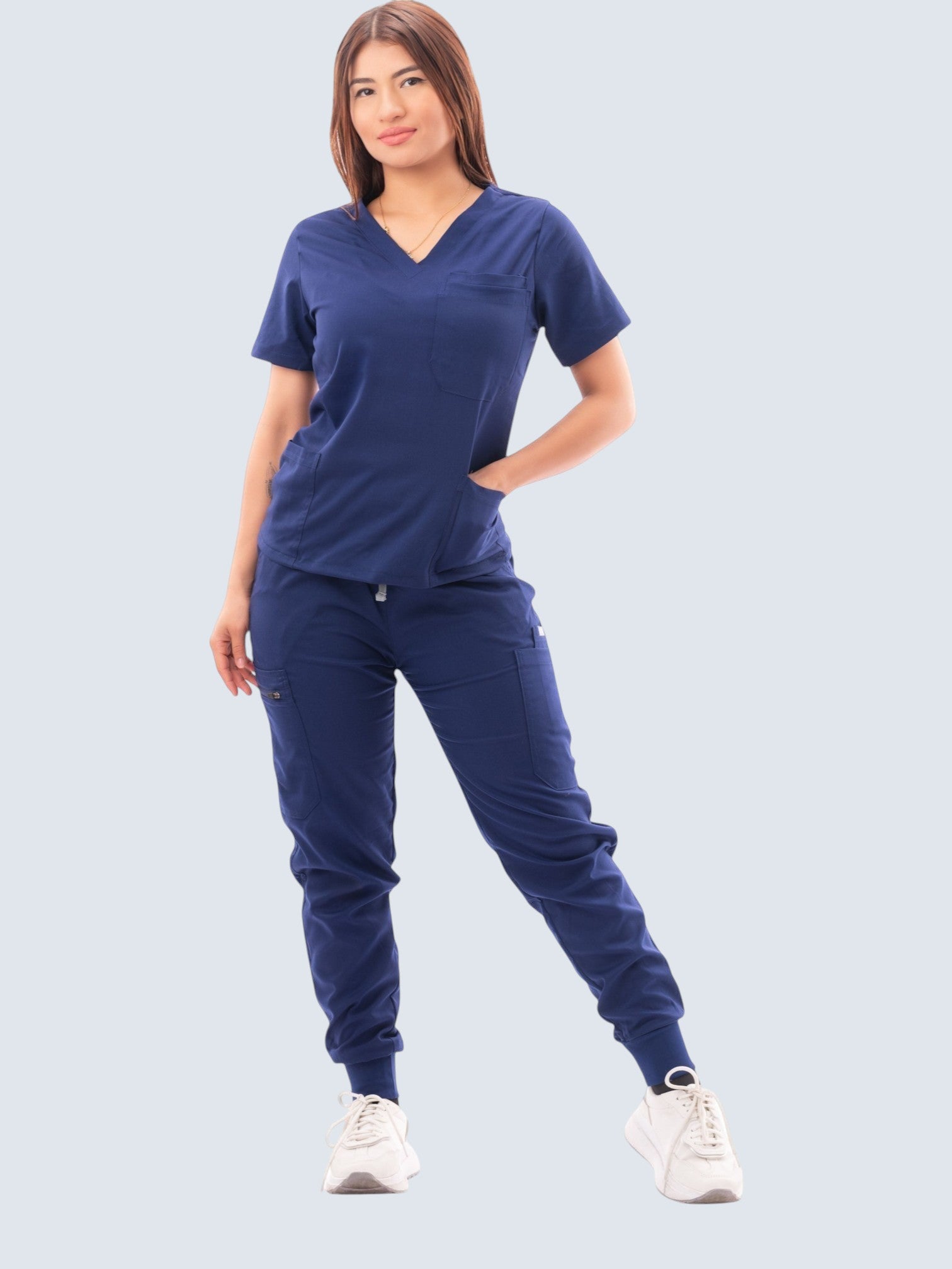 Kotyss women's navy blue V-neck scrub top and jogger pants set with multiple pockets on a model