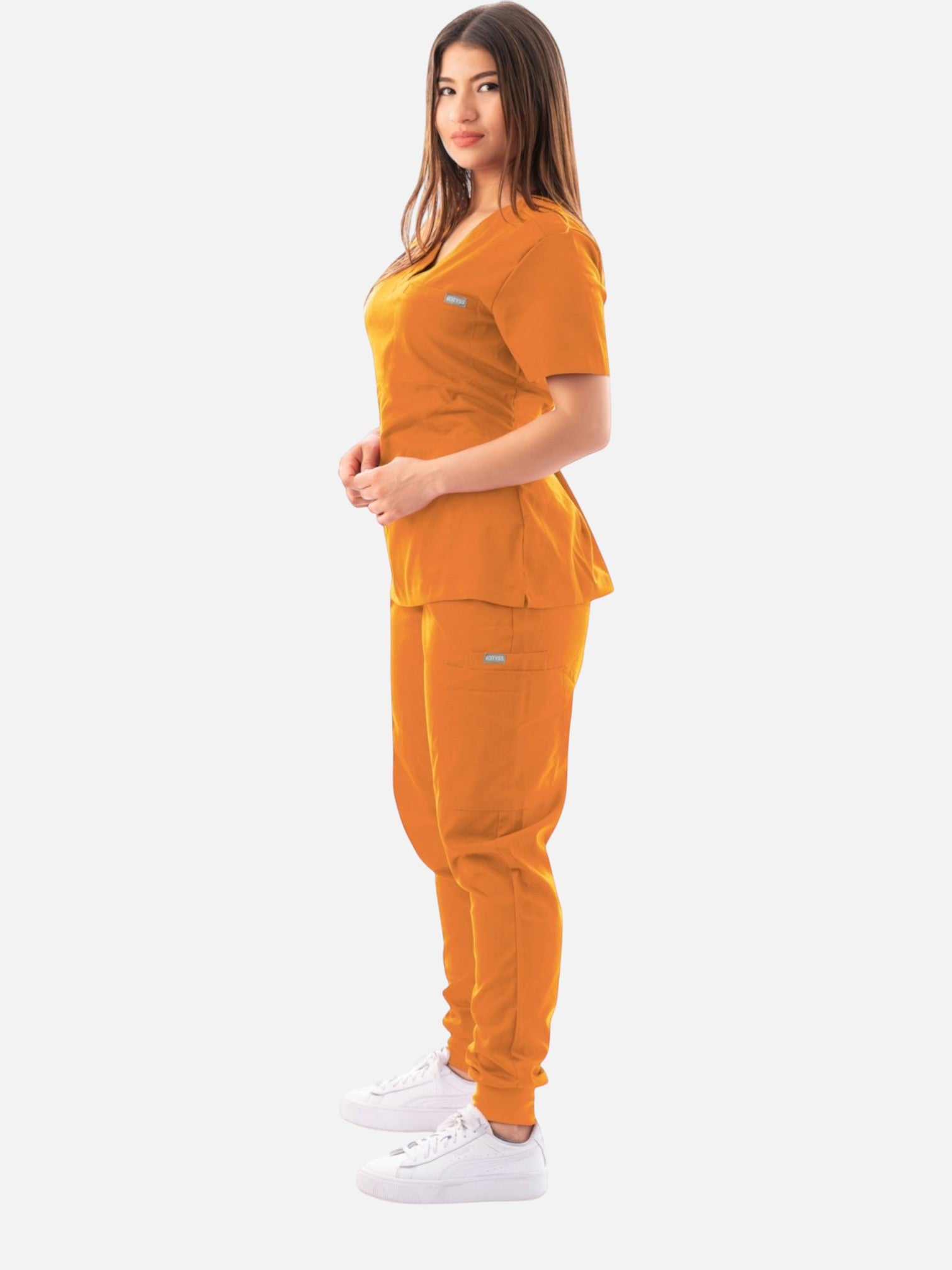 Kotyss women's orange V-neck scrub top and jogger pants set with multiple pockets, worn by a model in profile view.