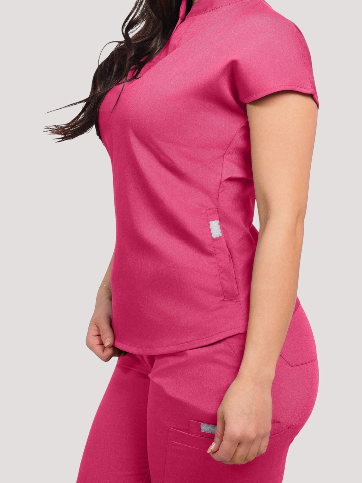 Kotyss women's hot pink collared scrub top and jogger set in breathable, wrinkle-free 4-way stretch fabric.