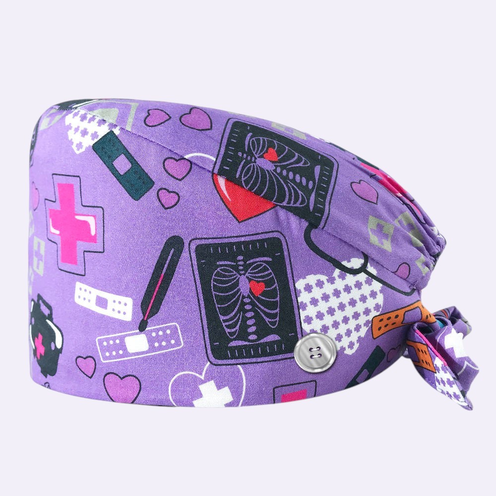 Kotyss purple cotton scrub cap with medical x-ray and heart print, featuring adjustable tie straps and side buttons.