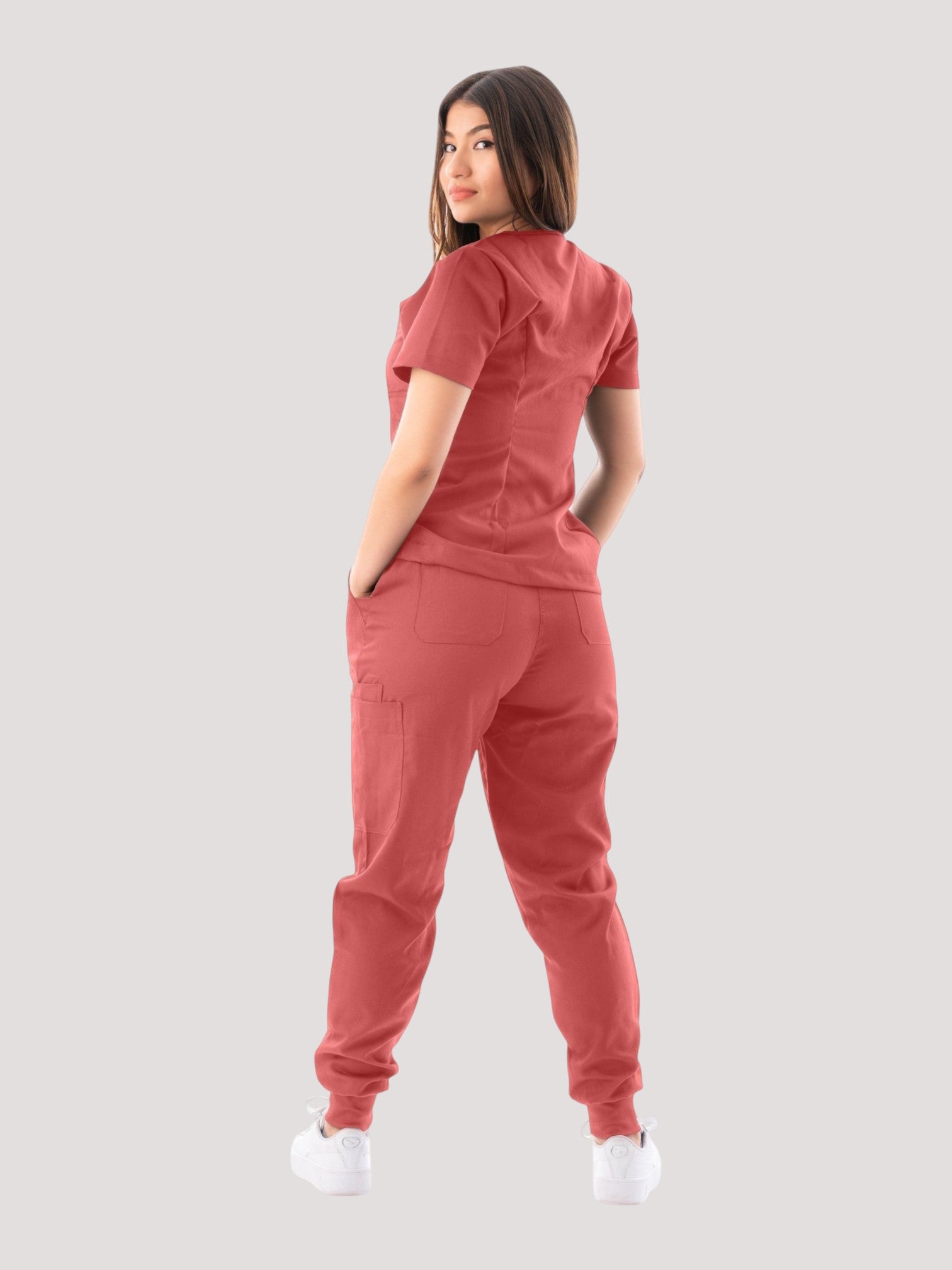 Kotyss women's red V-neck scrub top and jogger pants set, back view showing multiple pockets and breathable fabric.
