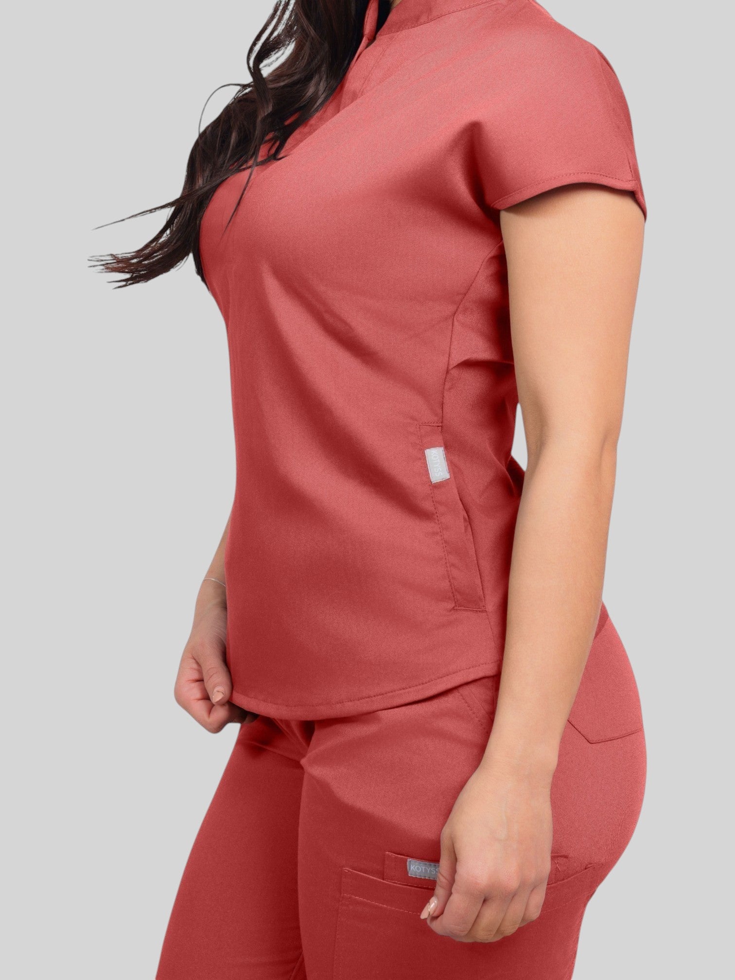 Kotyss women's terracotta collared scrub top and jogger set in breathable, 4-way stretch fabric, side view