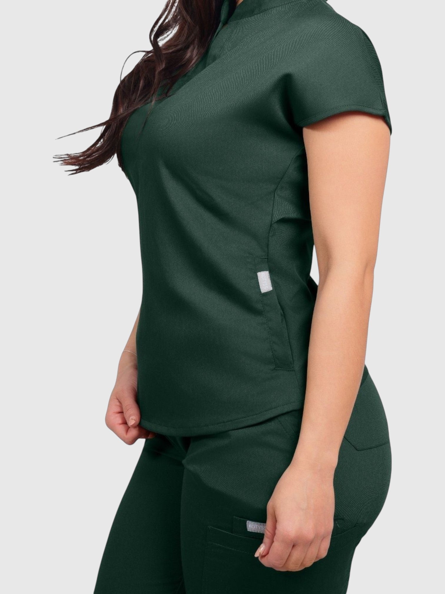 Kotyss women's dark green collared scrub top and matching jogger pants made from breathable 4-way stretch fabric.