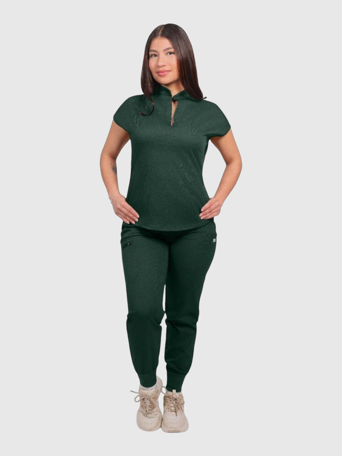 Kotyss women's dark green collared scrub top and jogger set with multiple pockets, worn by a model.